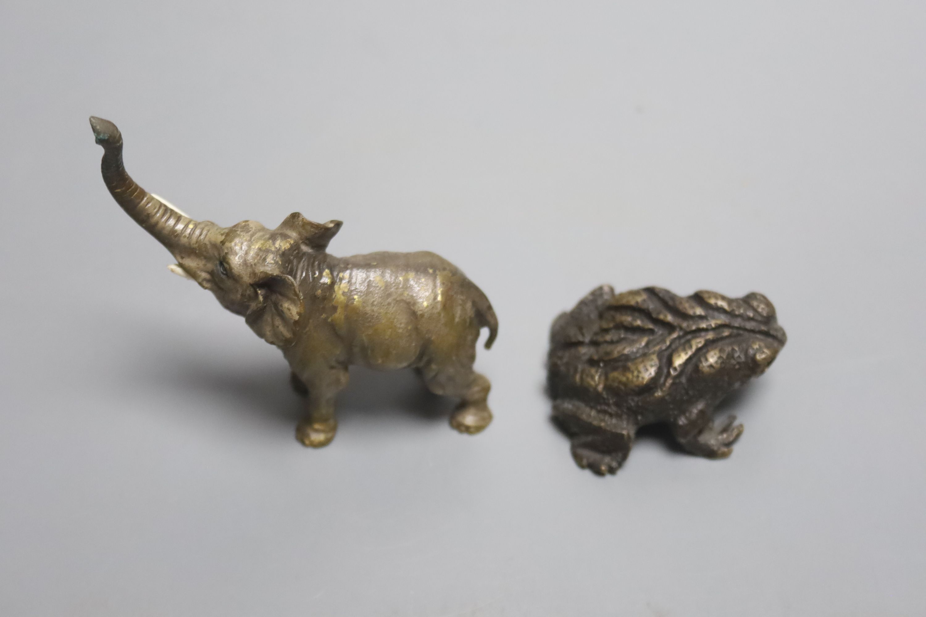 A miniature bronze elephant and a frog